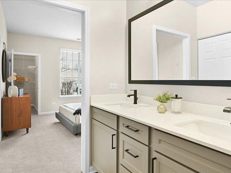 view from a bathroom into the bedroom and open closet