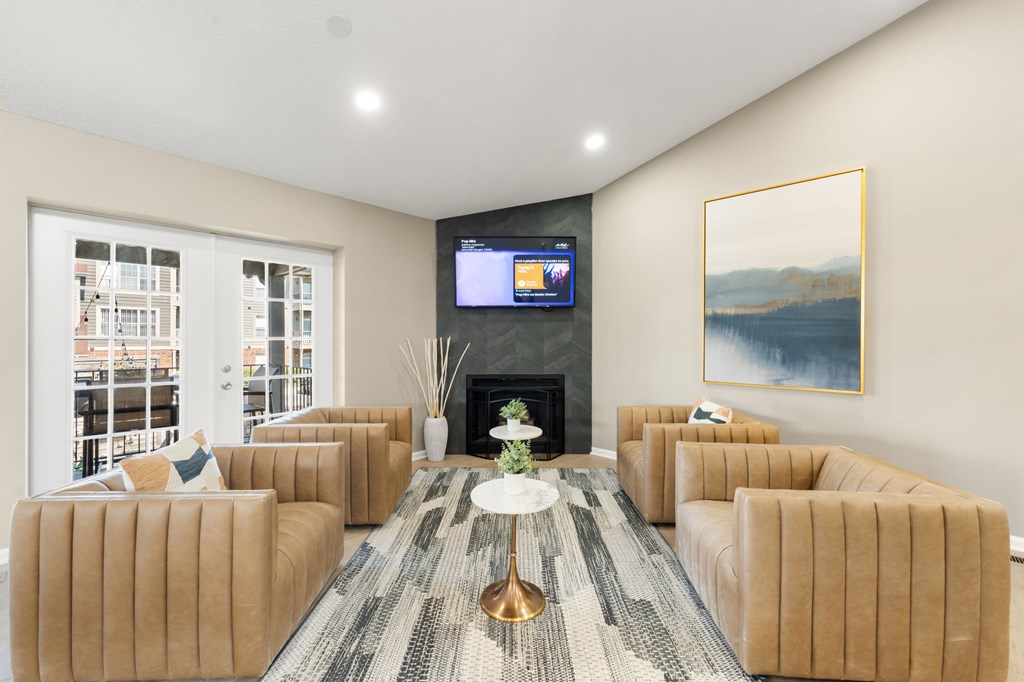 A living room with a fireplace, a television, and a painting on the wall.