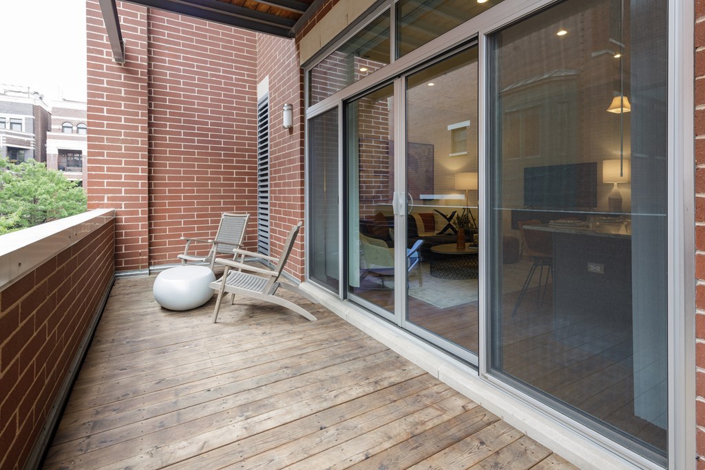 A balcony with a chair and table.