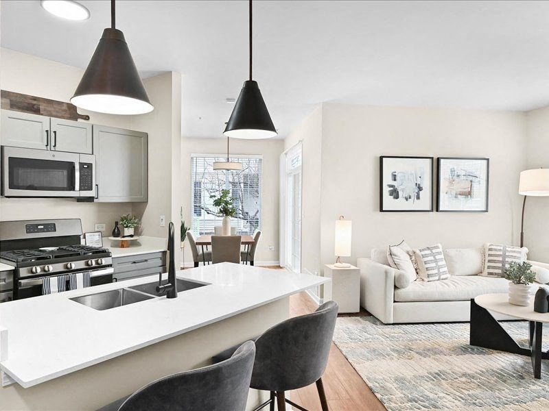 open floorplan featuring a modern kitchen and furnished dining and living room spaces