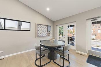 A dining room with a round table and chairs.