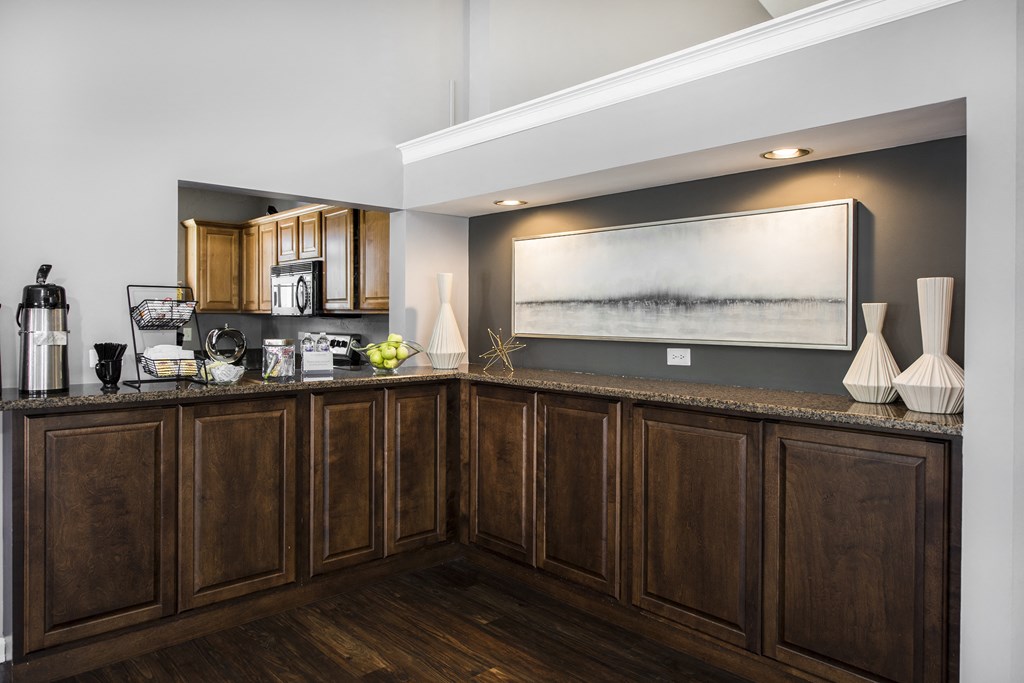 a kitchen with wooden cabinets and a large picture on the wall
