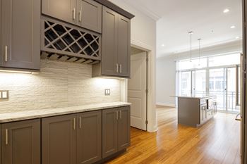 A kitchen with brown cabinets and a white counter top.