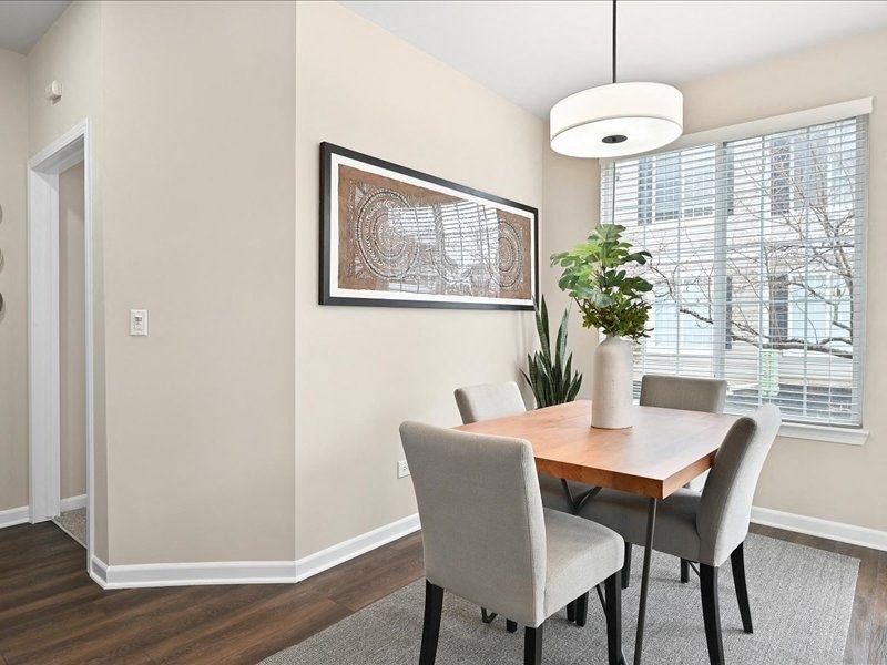 dining table situated near a large window and under a pendant light