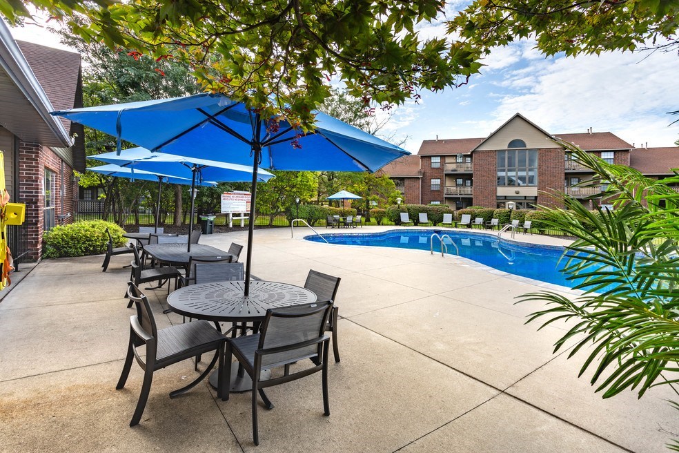 our apartments have a pool and patio with tables and umbrellas