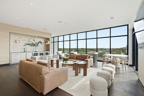 A living room with a large couch and a dining table.