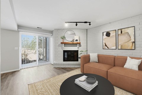 A living room with a fireplace and sliding glass doors.