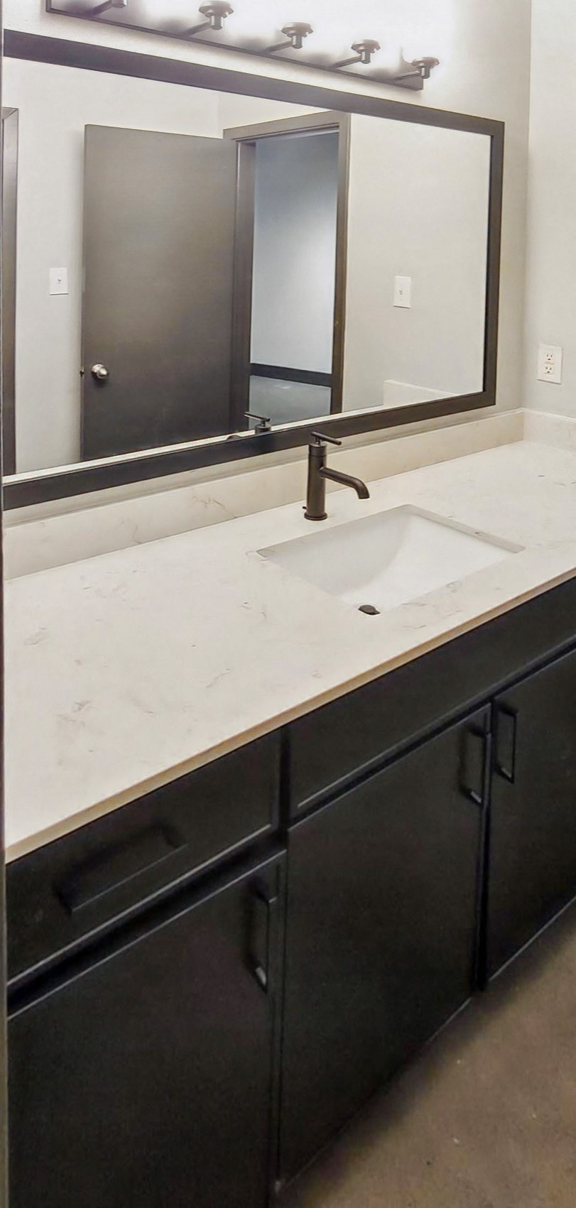 a bathroom counter with a sink and a mirror