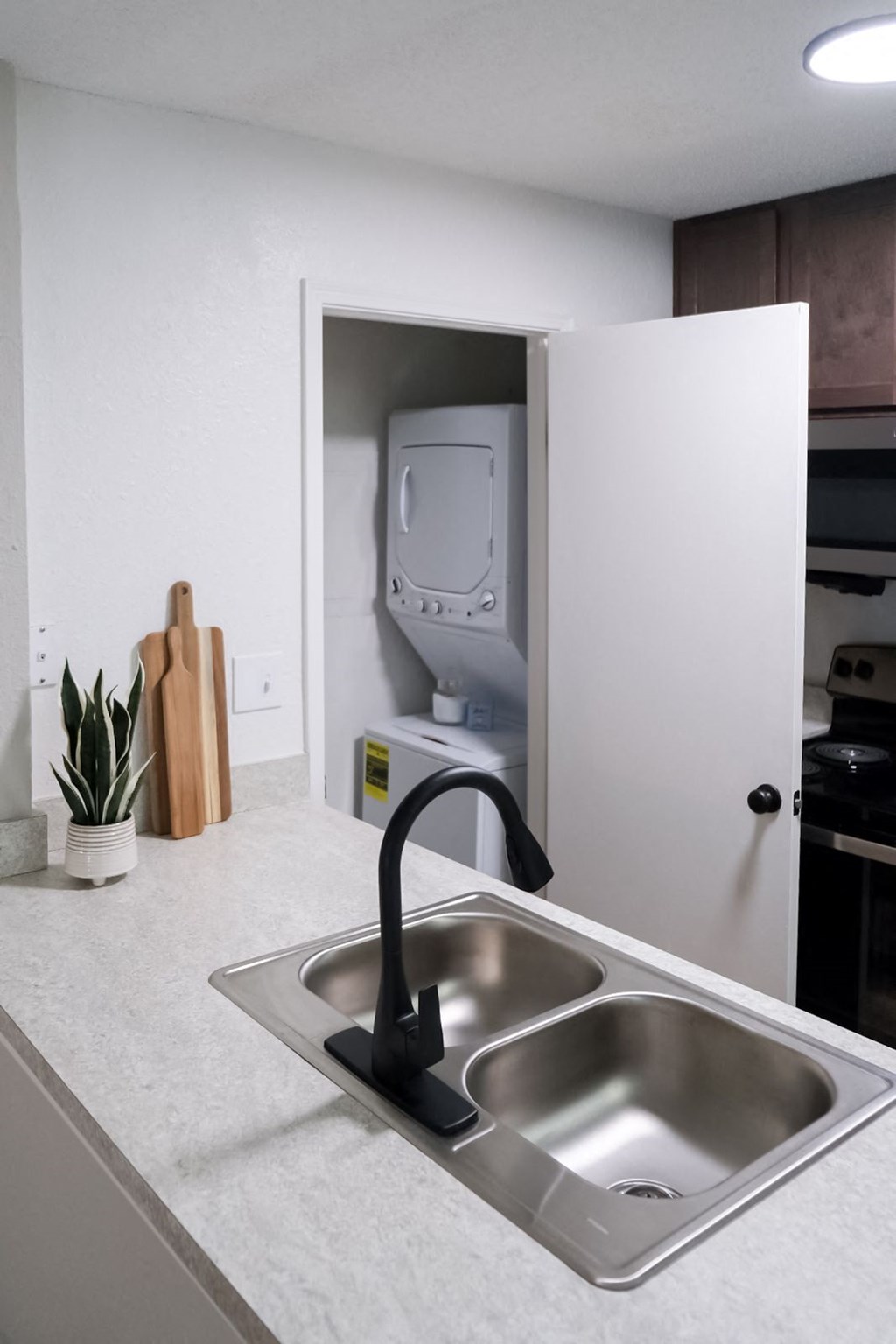 a kitchen sink in a 555 waverly unit with a washer and dryer in