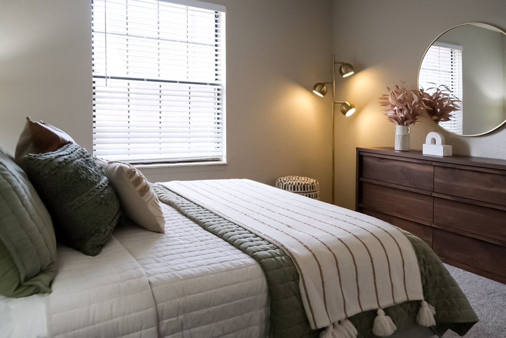 a bedroom with a bed and a dresser