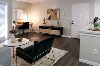 apartment living space with a dining table, desk, and tv console
