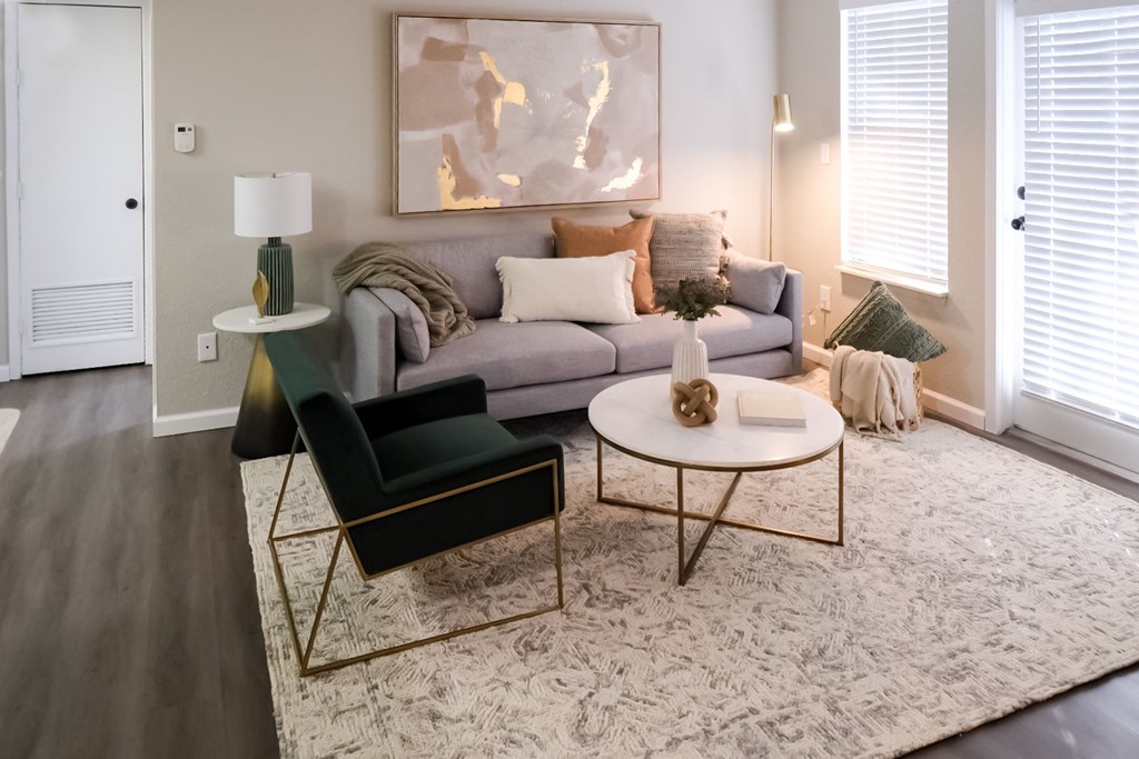 a living room with a gray couch and a white coffee table