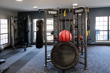a gym with a punching bag and other equipment