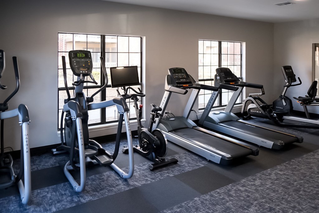 a gym with treadmills and ellipticals