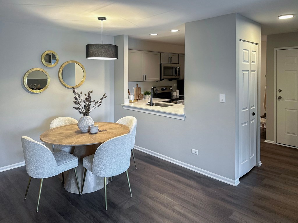 dining area with a table and 4 chairs next to the kitchen