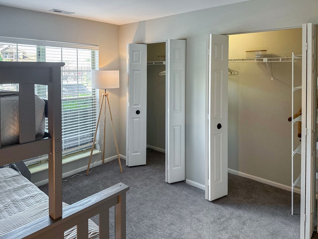 apartment bedroom with bunk beds and two closets
