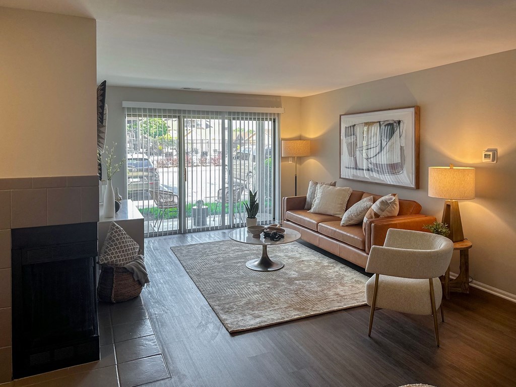 a living room with a couch chair and fireplace