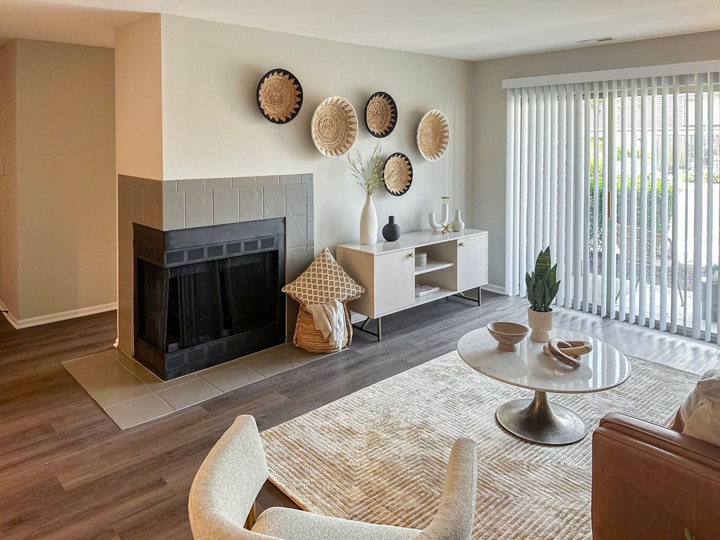 furnished apartment living room with a fireplace and patio access