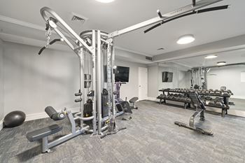 A well-equipped gym with a variety of machines and weightlifting equipment.