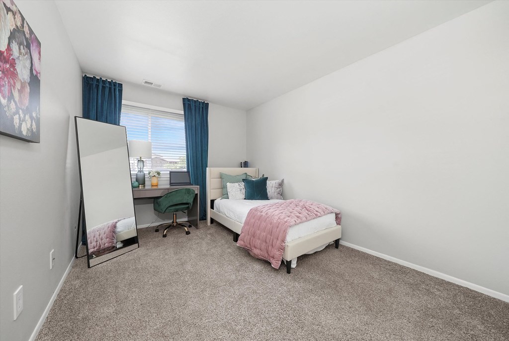 a bedroom with a bed and a mirror