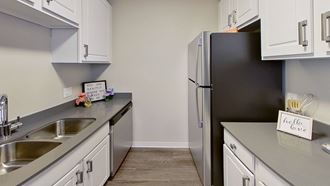 a kitchen with stainless steel appliances and white cabinets