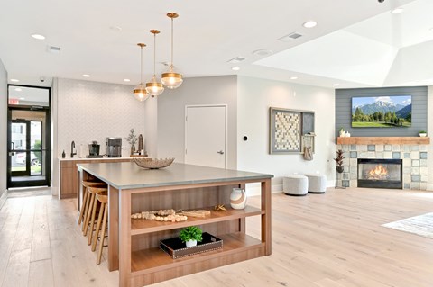 a large kitchen with a fireplace and a wooden table