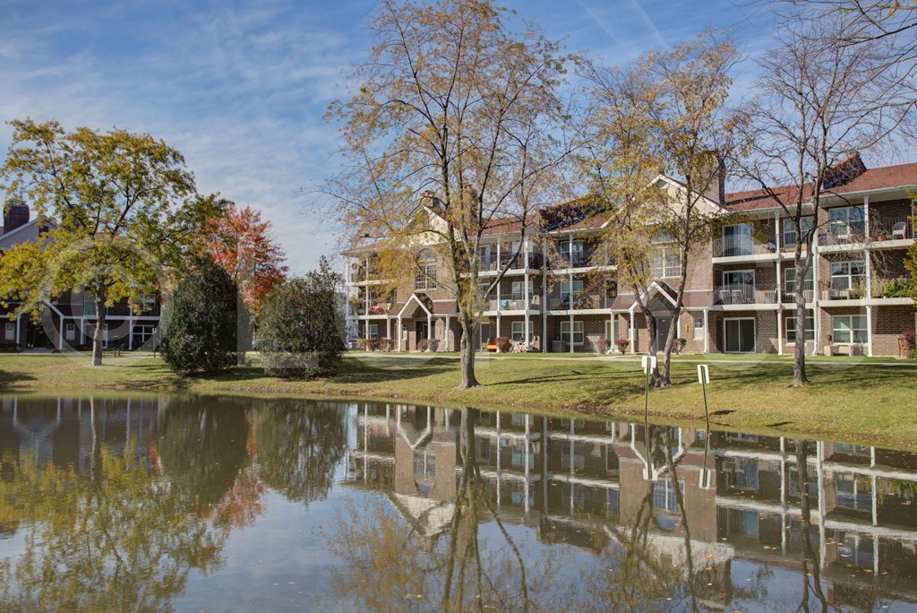 A large building is reflected in the water.