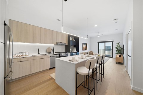A modern kitchen with a dining table and chairs.