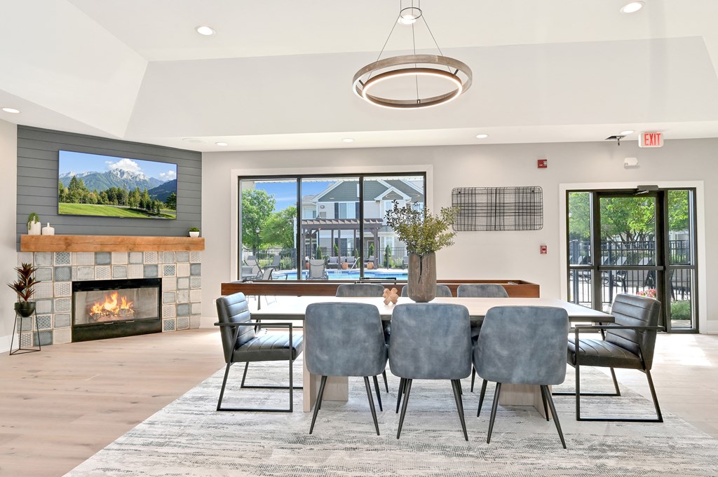 Farmington Lake's community clubhouse with a large dining table and indoor fireplace