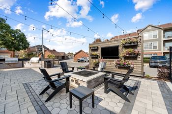 A patio with a table and chairs is set up for outdoor dining.