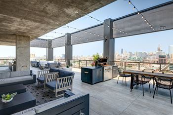 Rooftop sky lounge with bar, fireplace, game room and skyline views