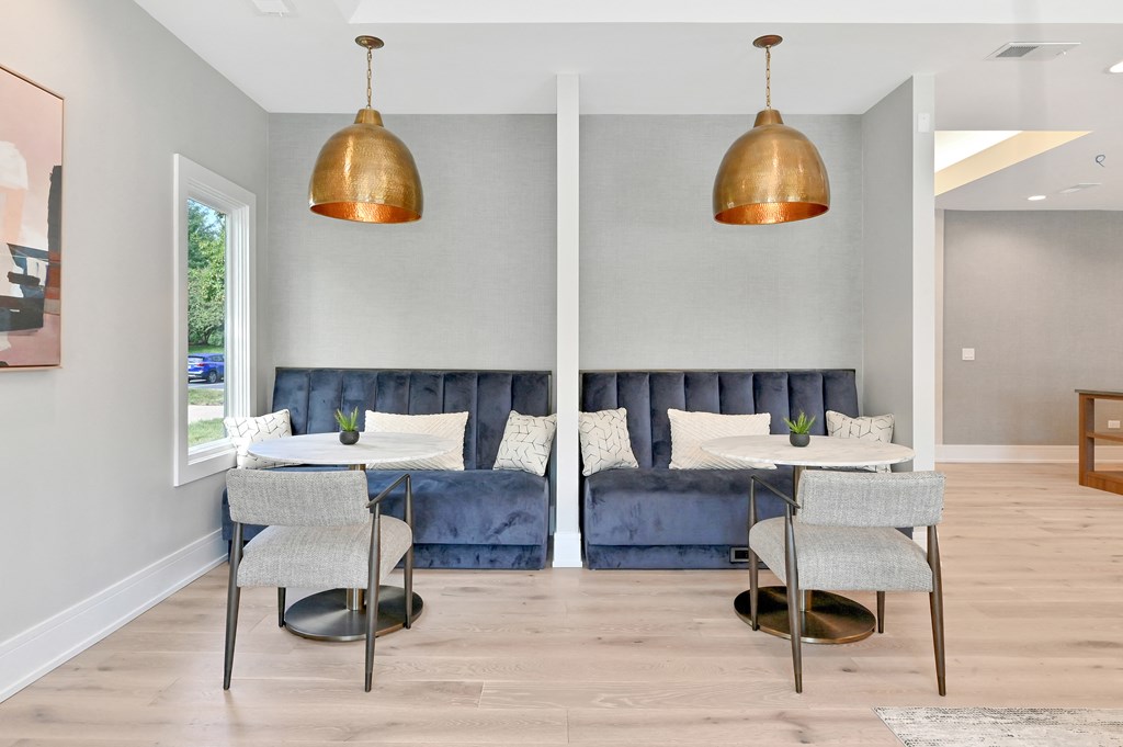 blue velvet booth seating under copper pendant lighting in the Farmington Lakes clubhouse
