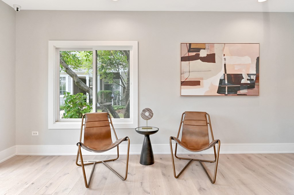 two accent chairs next to a small round side table