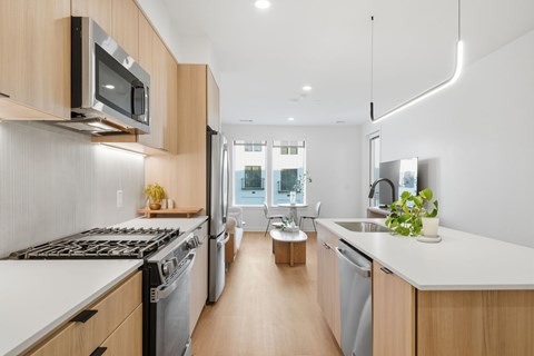 A modern kitchen with wooden cabinets and stainless steel appliances.