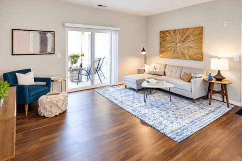 A living room with a blue couch and a white couch.