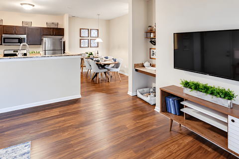 A modern kitchen with a dining table and chairs.