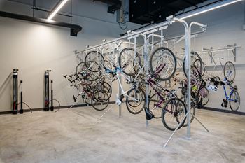 Expansive ground floor bike storage room with bike repair / maintenance work stations