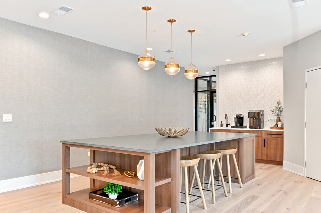 large island with shelving and three barstools