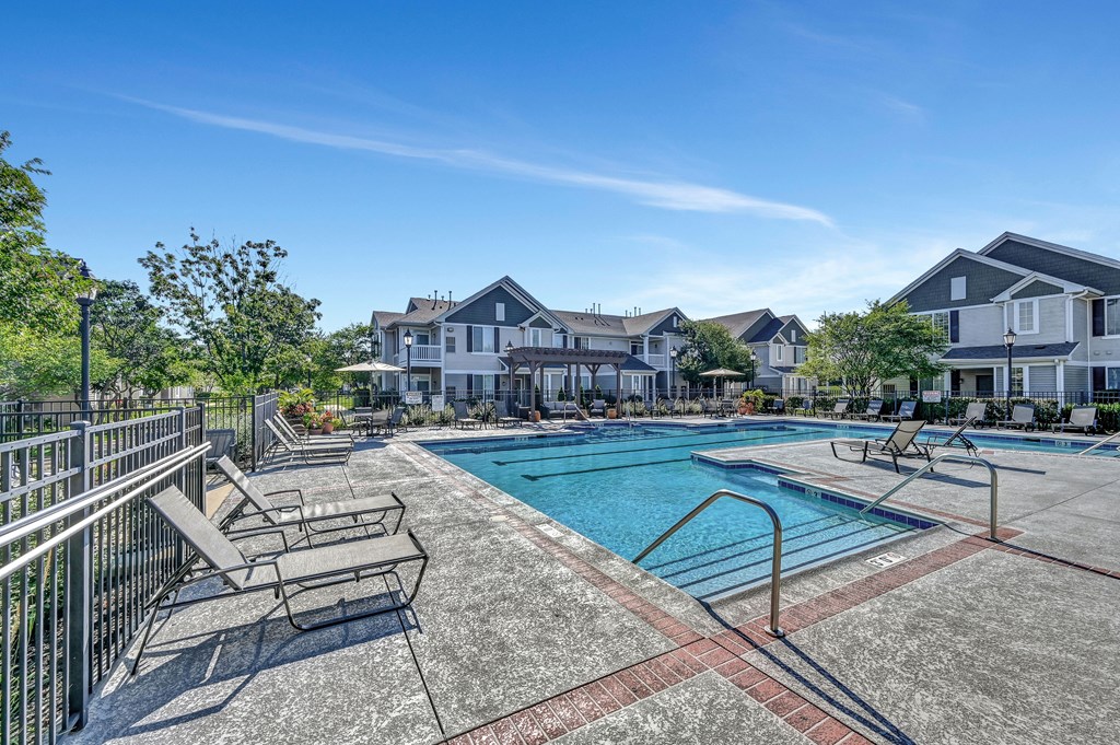 outdoor swimming pool with an expansive sundeck outside of Farmington Lakes Apartments in Oswego, IL