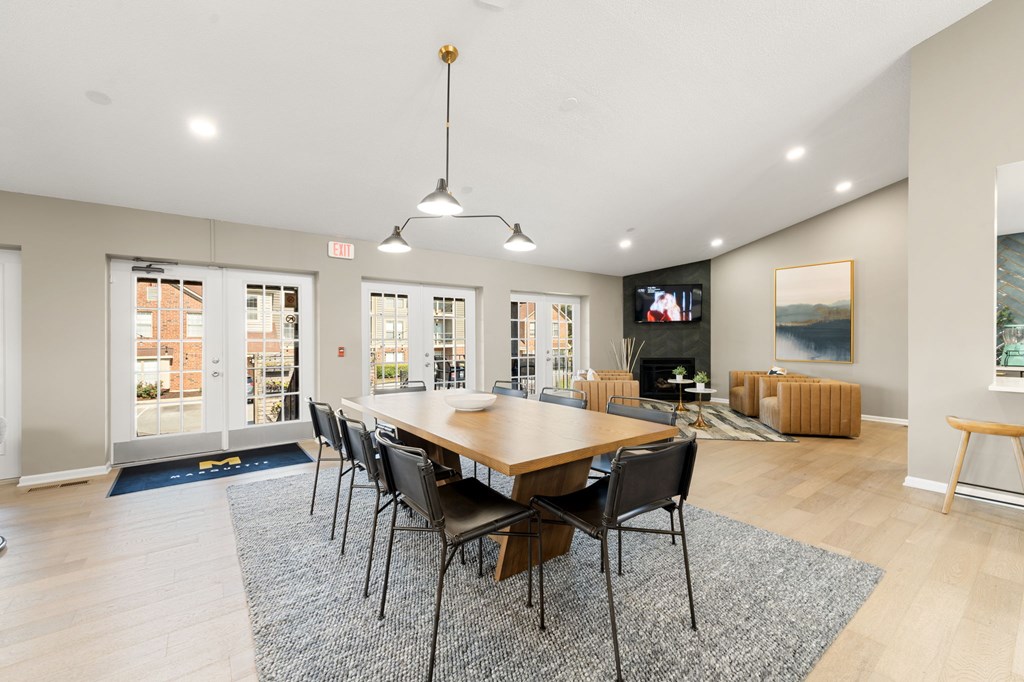 A modern dining room with a wooden table and chairs.