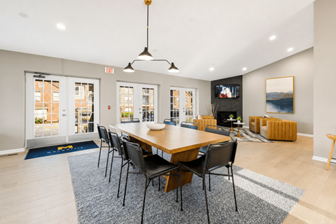 A dining room with a long table and chairs.