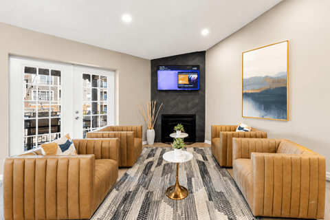 A living room with a fireplace and a television on the wall.