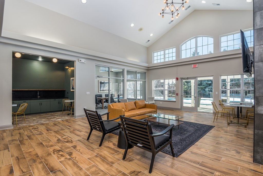 A spacious living room with a wooden floor and a large window.