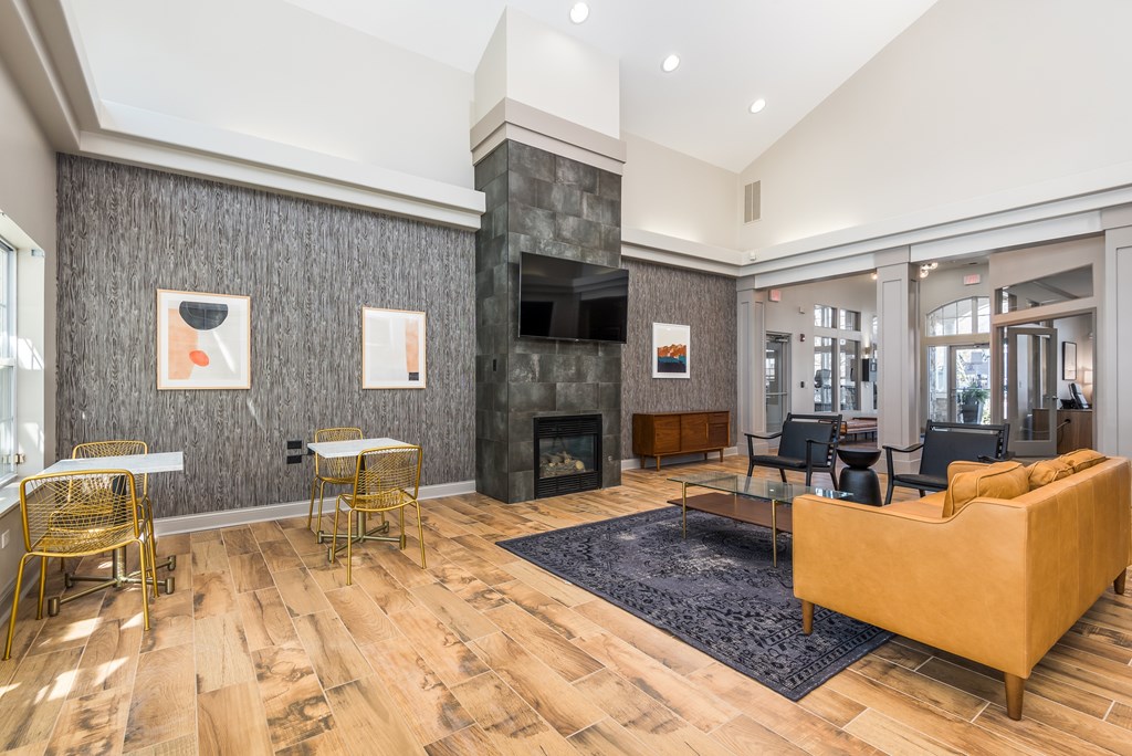 A living room with a fireplace and a yellow couch.