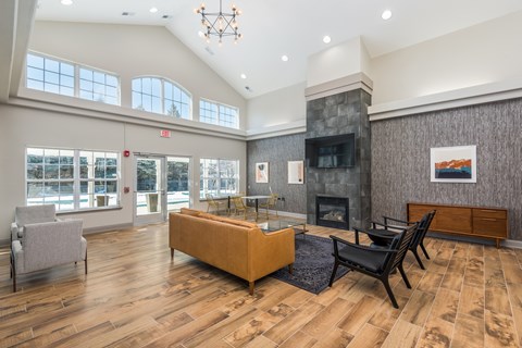 A living room with a fireplace and a painting on the wall.