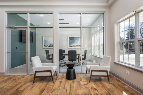 A room with a glass door and a table with chairs.