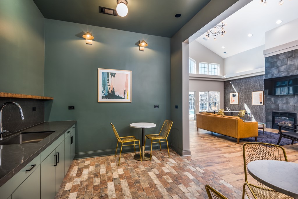 A kitchen with a table and chairs in the middle of the room.