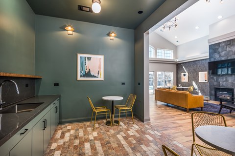 A kitchen with a table and chairs in the middle of the room.