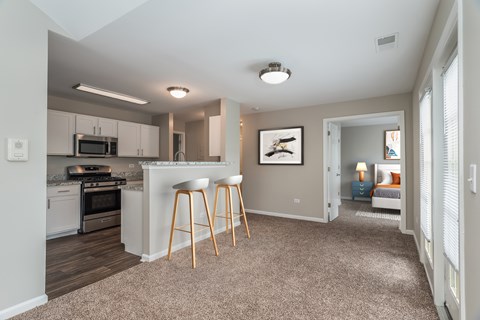A kitchen with white cabinets and a microwave above the stove.