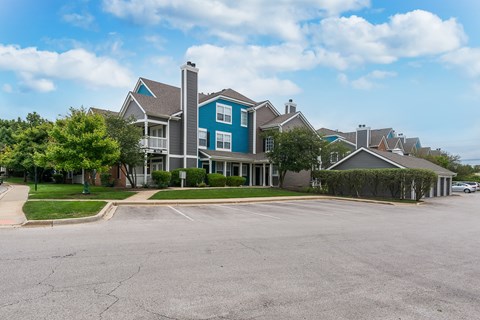 A blue and grey house with a driveway in front.